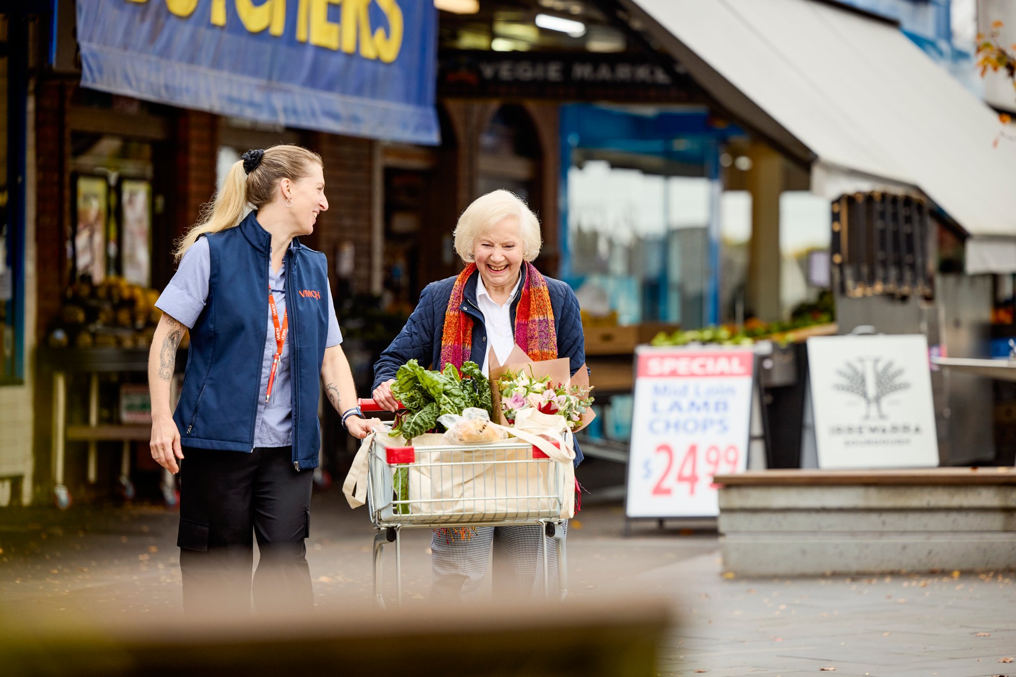 Elderly woman receiving assistance with grocery shopping