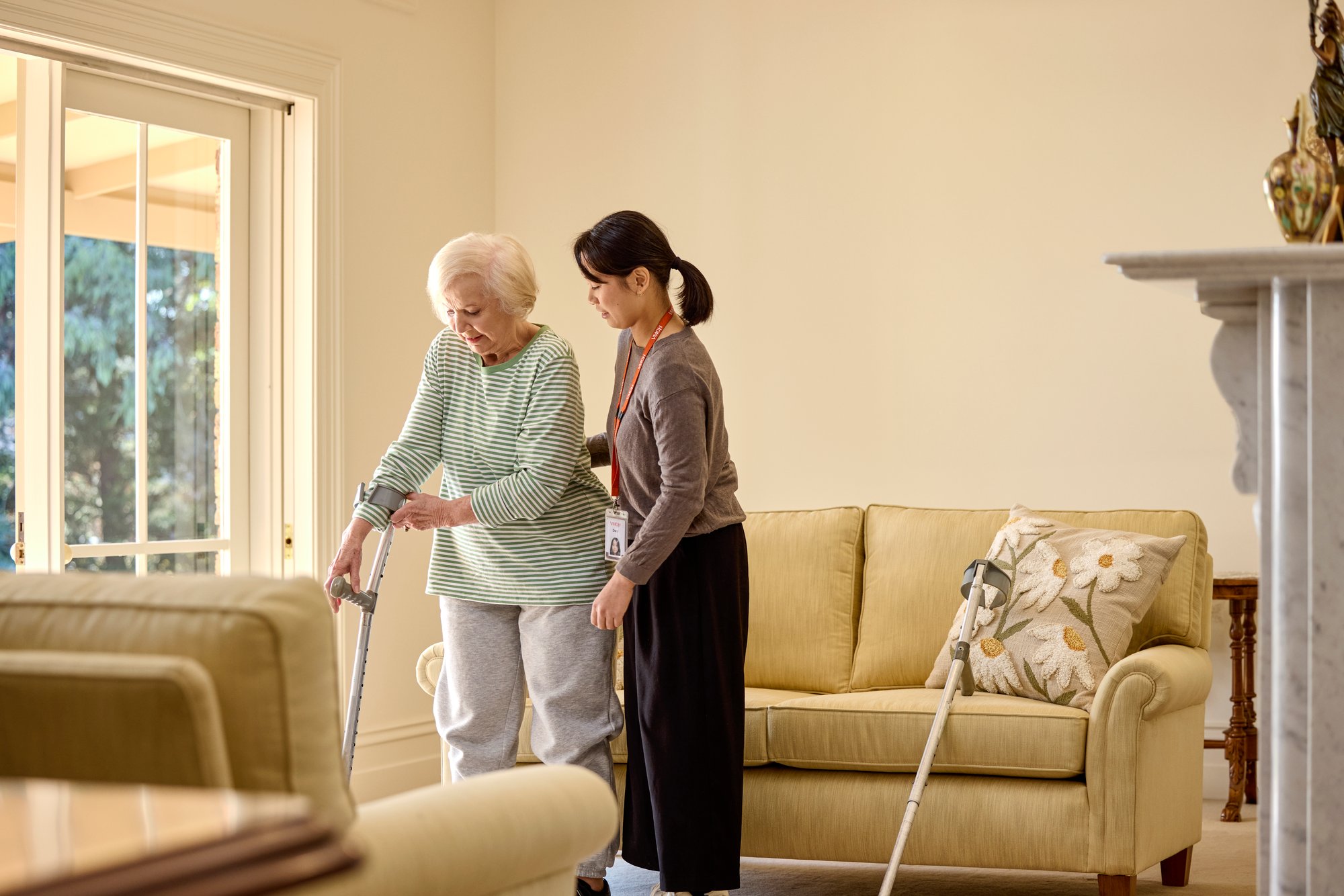 Elderly woman receiving assistance from aged care worker