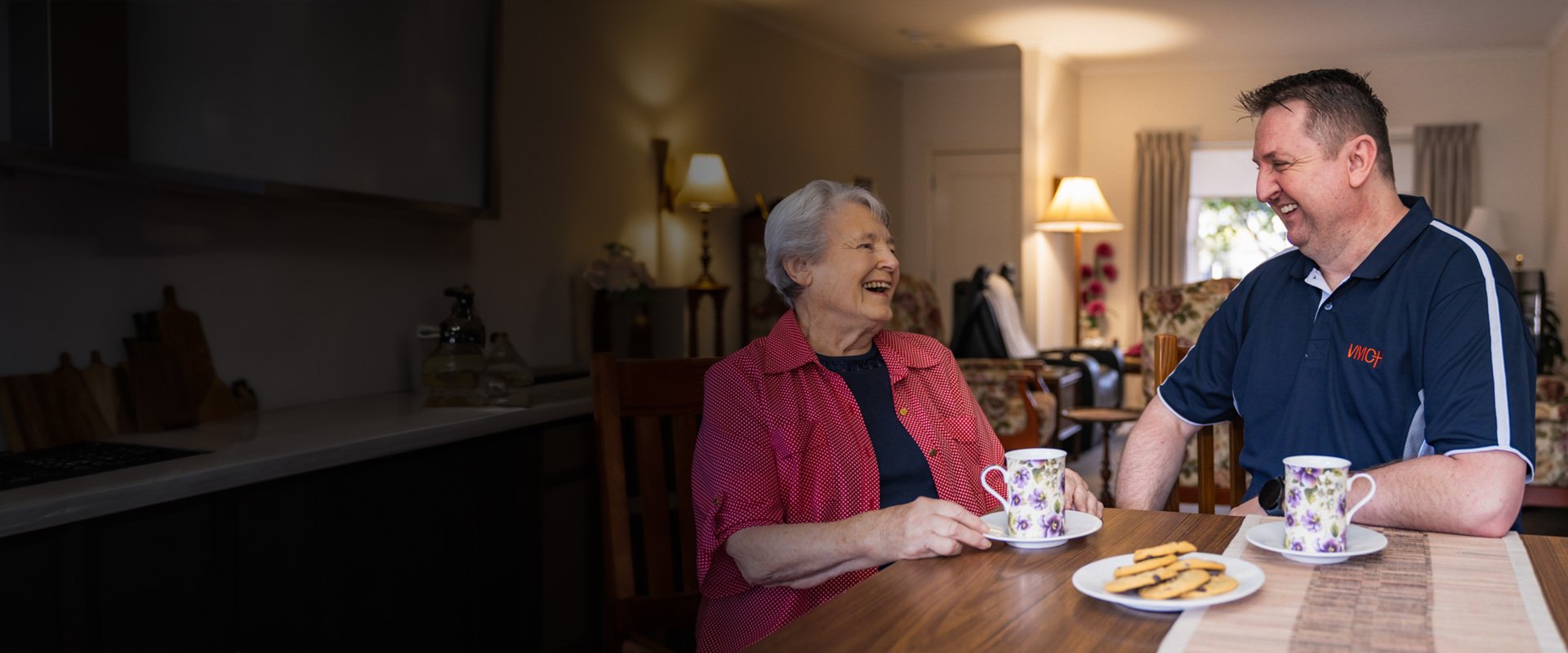 Elderly woman having a cup of tea with an Aged Care worker
