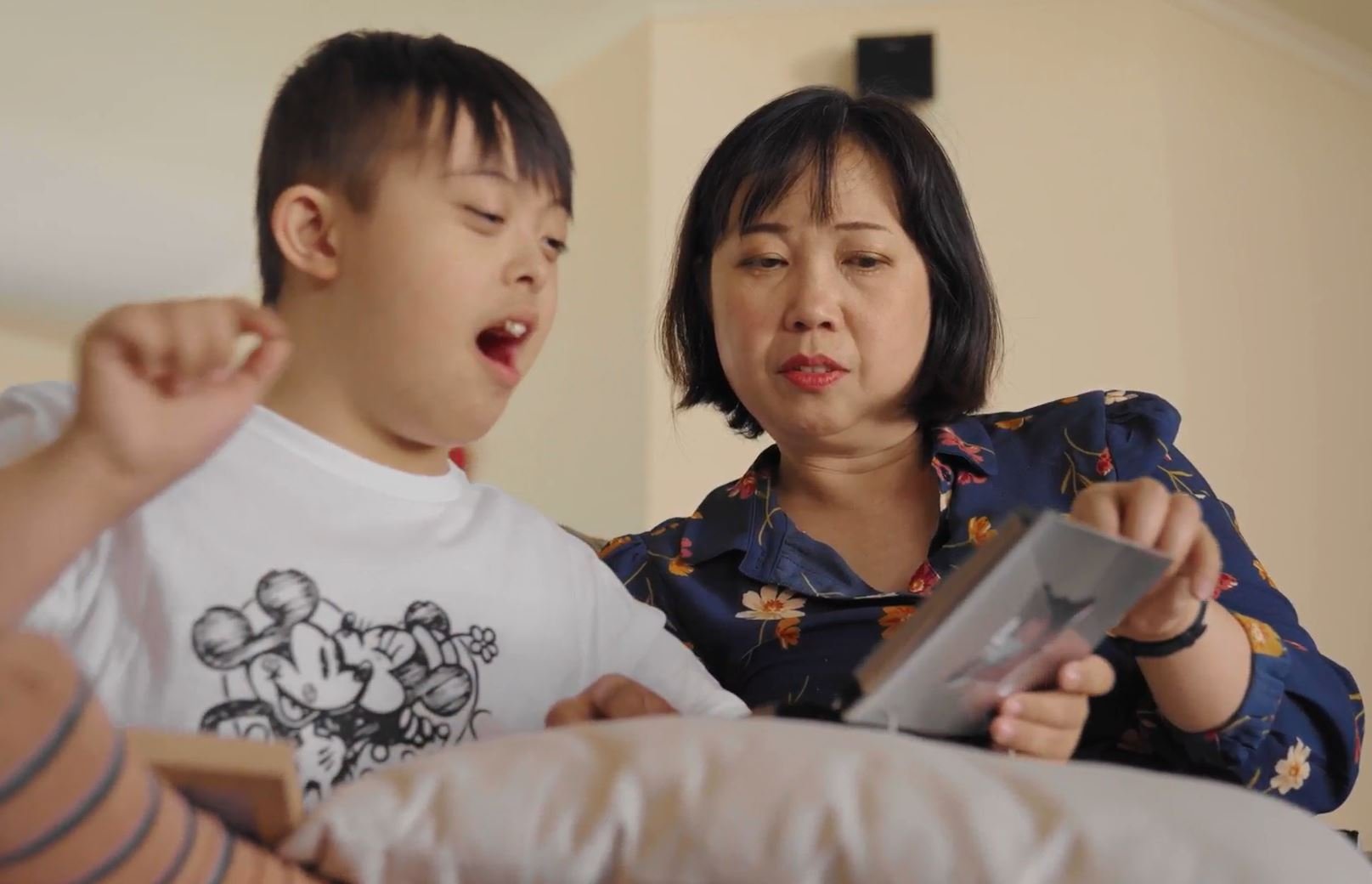 A mother and child looking at photos.
